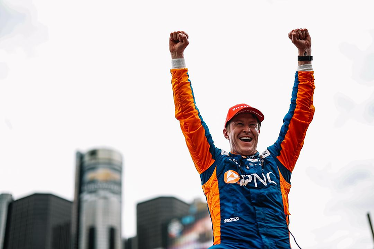 Driver lifting his arms in victory celebration