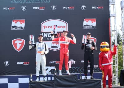 Jacob Abel, Louis Foster and Bryce Aron stand on the podium at Portland.