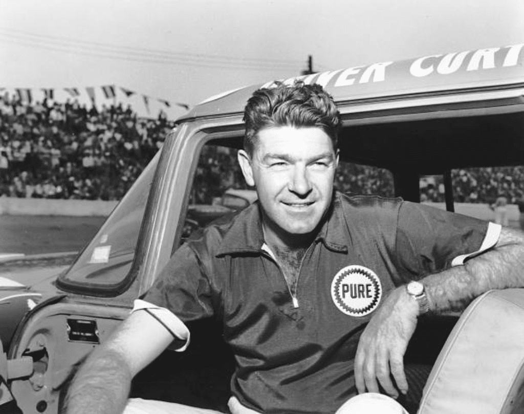 Curtis Turner looks on.