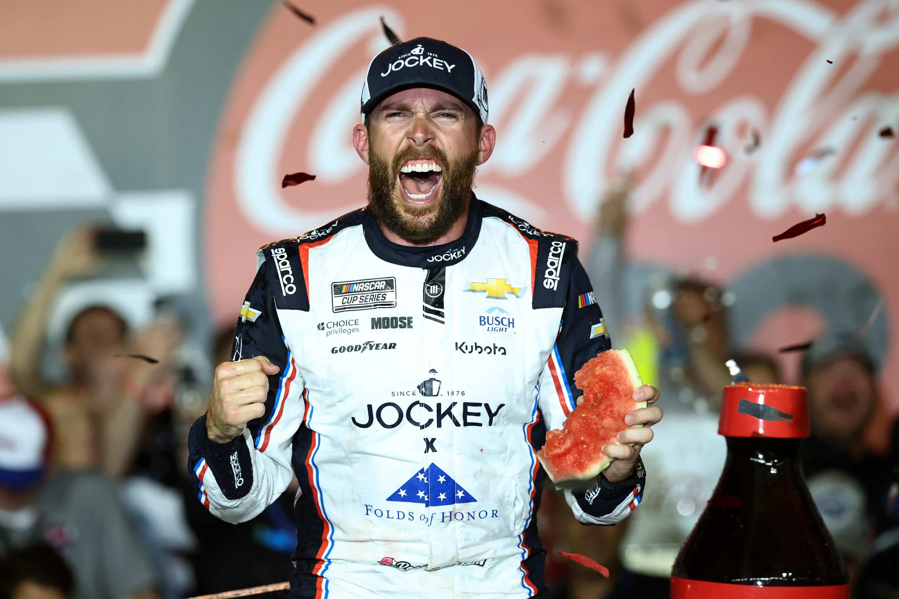 Ross Chastain celebrates in Victory Lane at Charlotte.