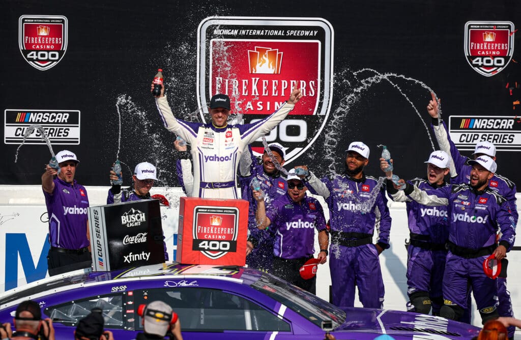 Denny Hamlin celebrates in Victory Lane at Michigan.
