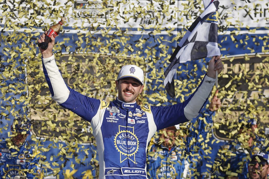 Chase Elliott celebrates in Victory Lane at Kansas.