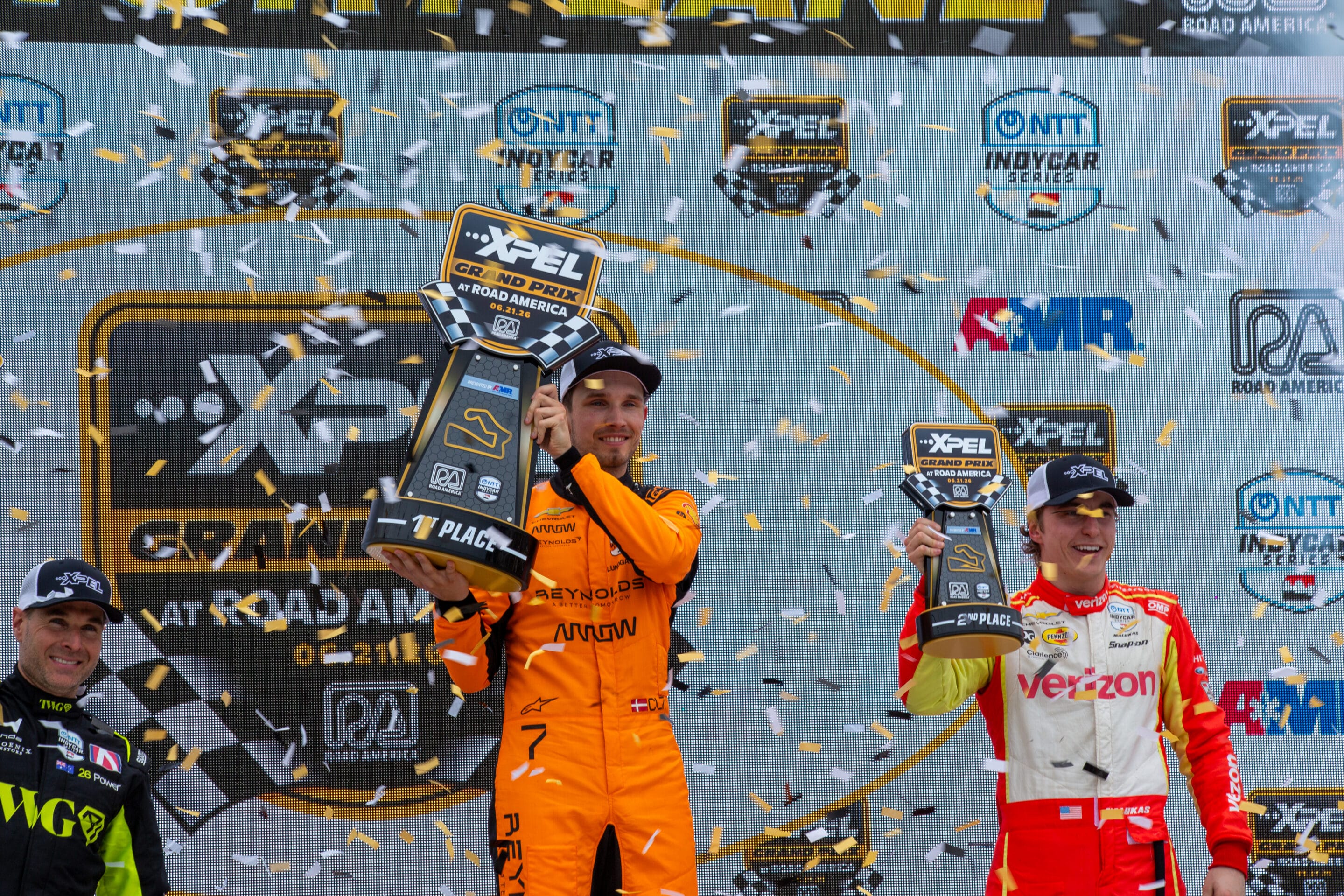 Will Power, Christian Lundgaard and David Malukas celebrate on the podium at Road America.