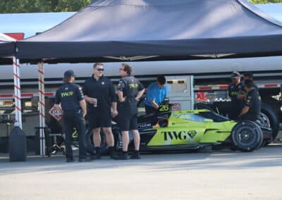 Will Power's car sits in the paddock at Portland.