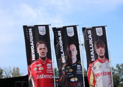A general view of banners showing Josef Newgarden, Scott McLaughlin and David Malukas.