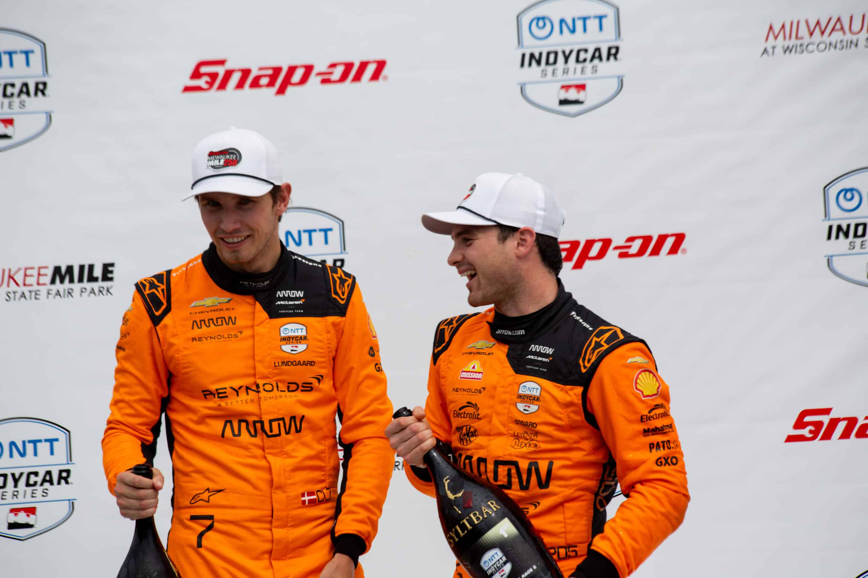 Christian Lundgaard and Pato O'Ward celebrate on the podium at Milwaukee.